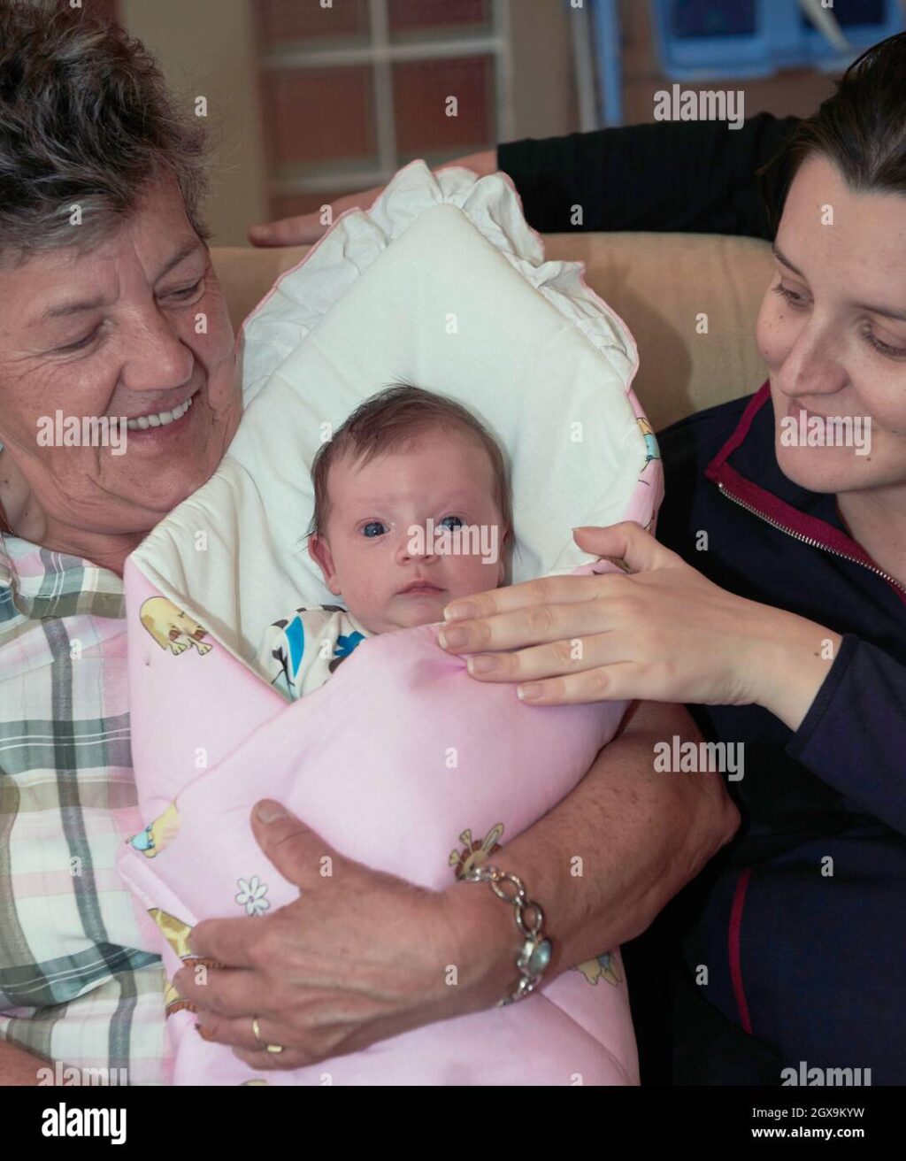 generations-family-portrait-with-grandparents-parents-and-newborn-baby-2GX9KYW